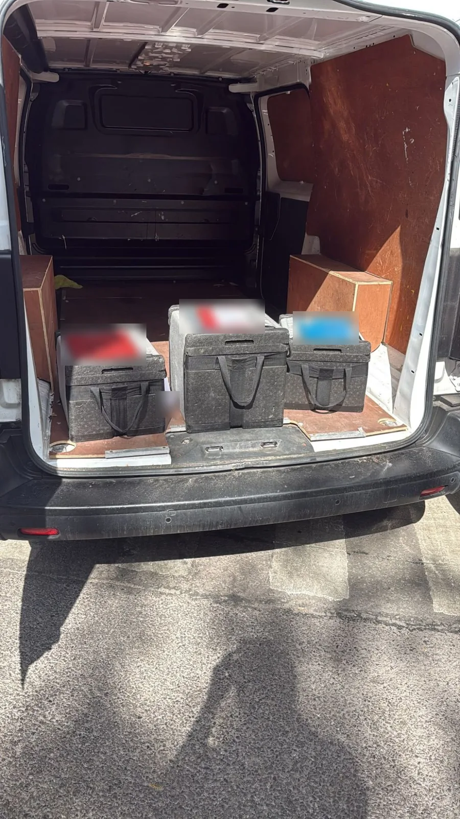 A Red Eagle Logistics van loaded with transport boxes for a dedicated same-day courier run