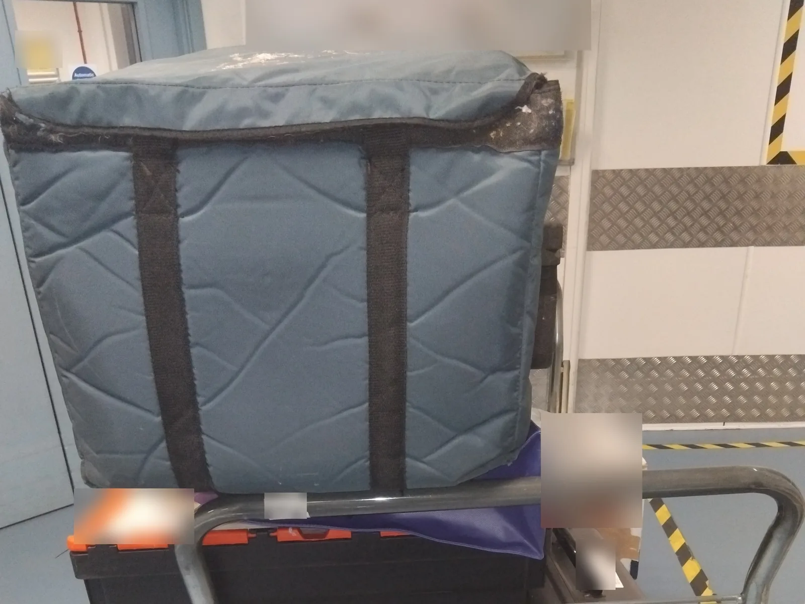 Insulated medical delivery bag and transport cases on a trolley for Red Eagle Logistics same-day courier collection