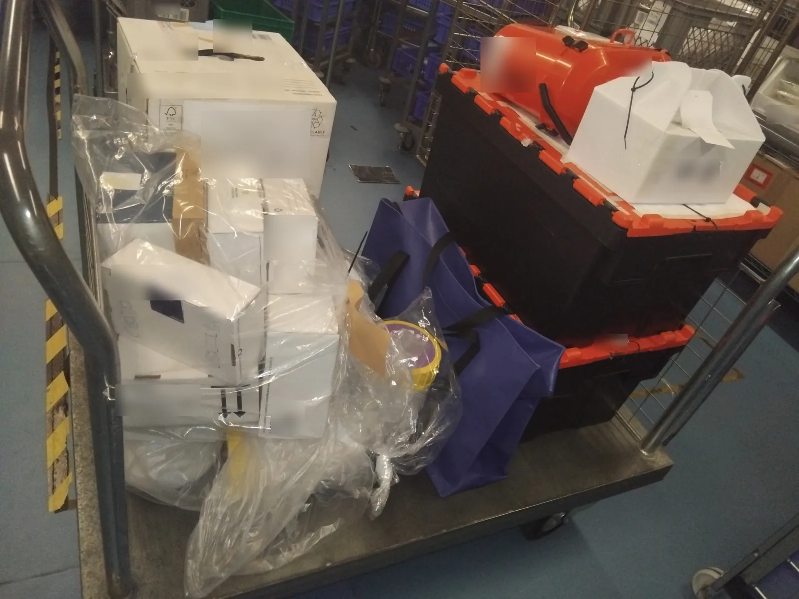 Trolley of medical specimen packaging and transport cases ready for Red Eagle Logistics biological sample collection