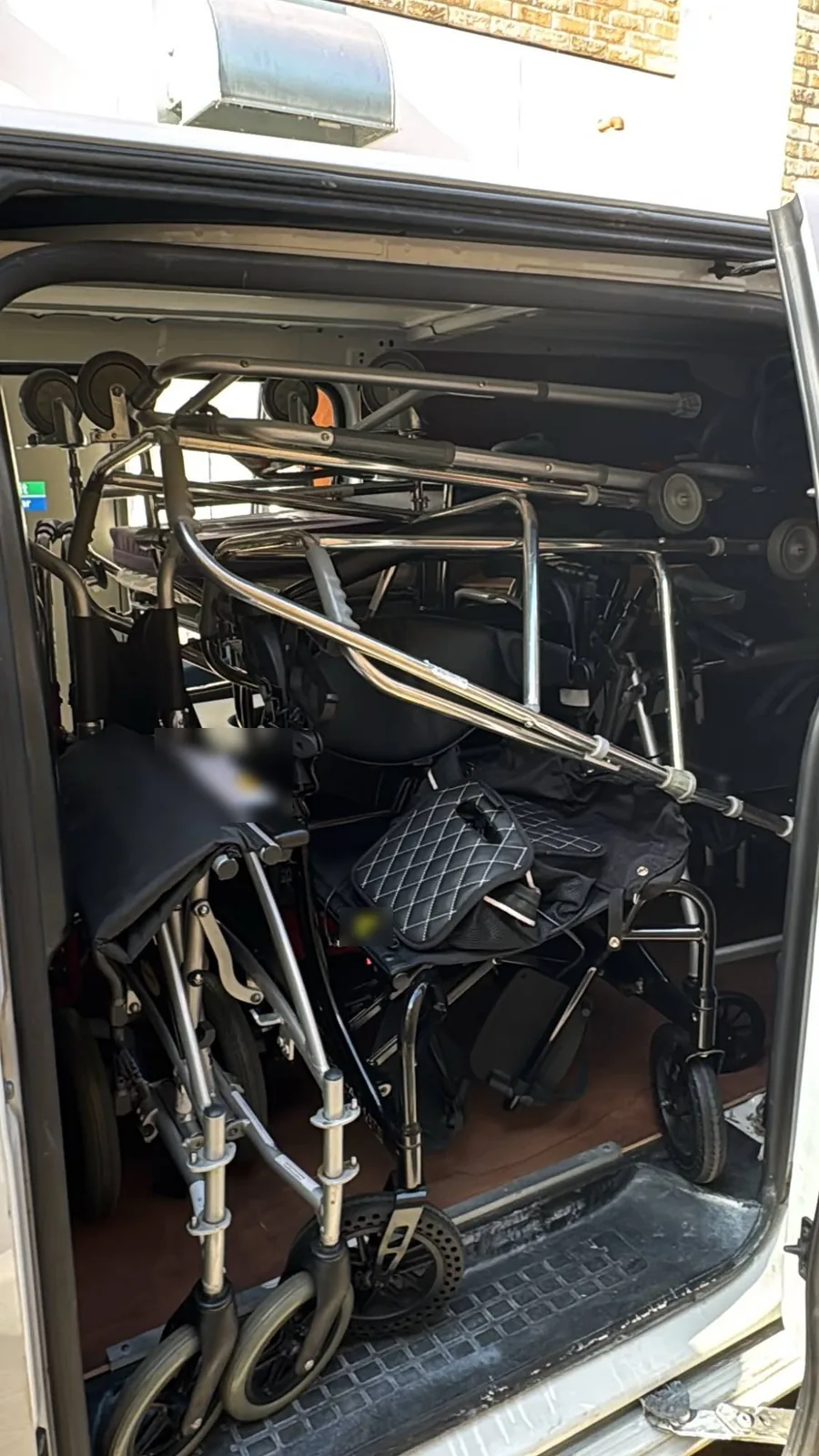 Wheelchairs and walking frames loaded through the side door of a Red Eagle Logistics van for a London to Peterborough delivery