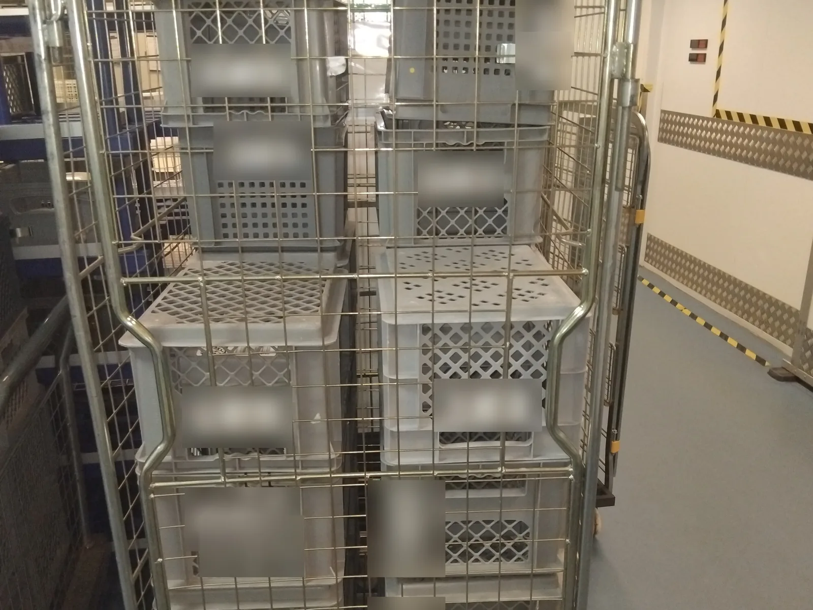 Returnable transport crates loaded on a roll cage at a Red Eagle Logistics distribution depot
